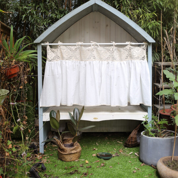 Boho kitchen window curtain hanging on outdoor cottage small window