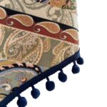 Close‑up of navy blue pom‑pom tassel fringe on vintage boho piano cover