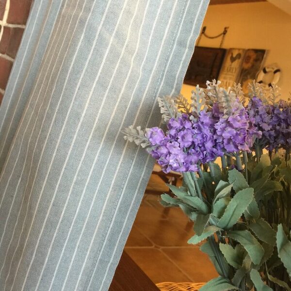 Texture close‑up of blue‑white striped sheer fabric for doorway curtain