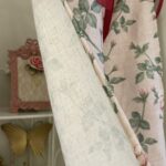 Texture close‑up, vintage rose floral print on linen‑look slub fabric for cottage tie‑top curtain