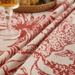 Close‑up of linen‑look cotton‑poly fabric, vintage red jungle leopard bird branch print