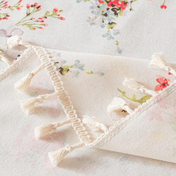 Back detail shot of tropical floral table cloth with tassel trim