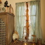 Vintage farmhouse room styled with green gingham cafe window curtain