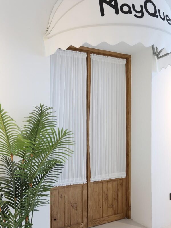 white dual rod pocket curtain decor on wooden doorway with houseplant