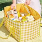 Yellow‑white check picnic tote blanket packed with outdoor food supplies