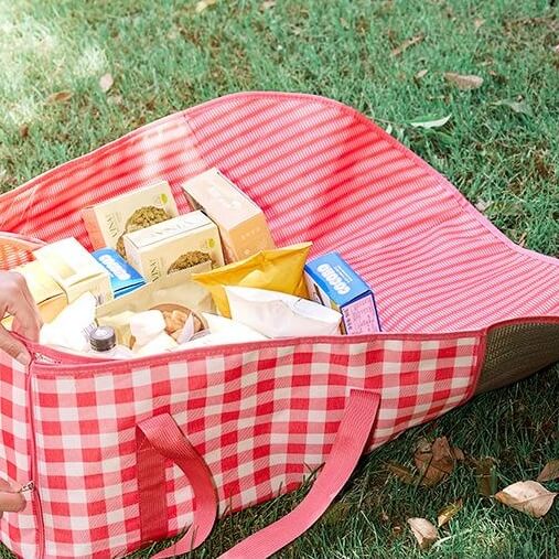 Convertible picnic blanket transitions between tote bag and ground mat