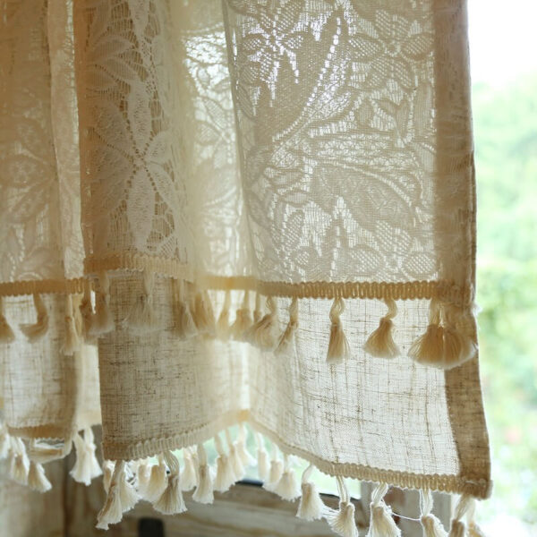 Close‑up of leaf‑pattern lace fabric and tassel fringe on double layer short curtain