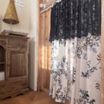 Timeless Parisian short curtain mounted on wooden indoor door, elegant lace‑top semi‑blackout window treatment