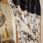 Close‑up floral fabric detail on timeless Parisian short curtain, black‑blue flower print with black lace header