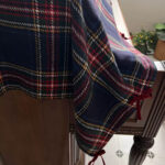 Heavy‑weight vintage plaid piano dust cover laid over upright piano top, farmhouse decor
