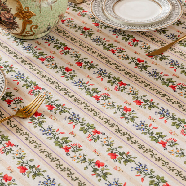 Close‑up of neat row‑arranged ditsy floral print on rectangular tablecloth fabric