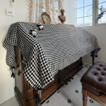 Upright piano cover cloth, black‑white diamond‑check dust cloth with cute panda ornaments and black tassel fringe on wooden upright piano