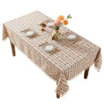 Water‑resistant rectangular ditsy floral tablecloth with tassel fringe on plain background