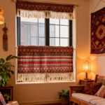 Boho geometric short curtain with tassel fringe, vintage tribal‑ethnic window panel hanging in warm southwestern‑style living room