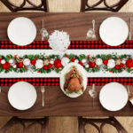 Buffalo plaid Christmas table runner with festive baubles for holiday dining