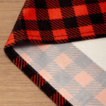 Water‑resistant Christmas table runner fabric close‑up, plaid reverse side