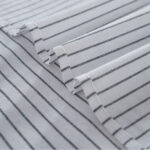 Closeup shot of woven texture on striped linen blend tablecloth