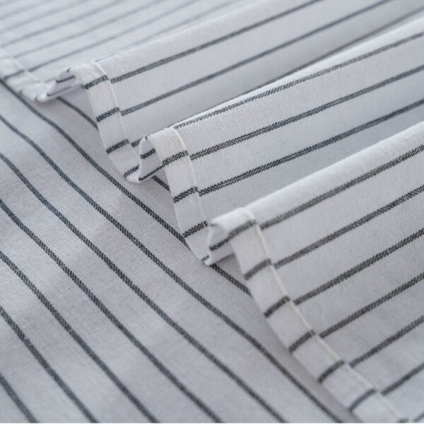 Closeup shot of woven texture on striped linen blend tablecloth