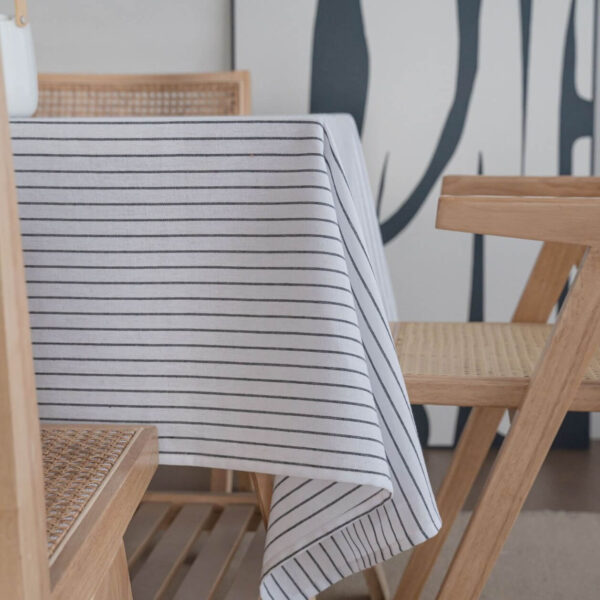 Thick striped linen blend tablecloth laid on wooden dining table