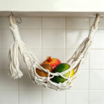 Macrame fruit hanging basket under kitchen cabinet, boho wall storage for fresh produce