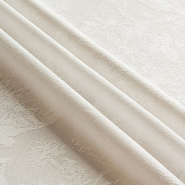 Detail shot of scalloped edge and floral jacquard lace texture