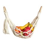Handmade cotton macrame fruit hanging basket filled with fresh fruits, off-white tassel design